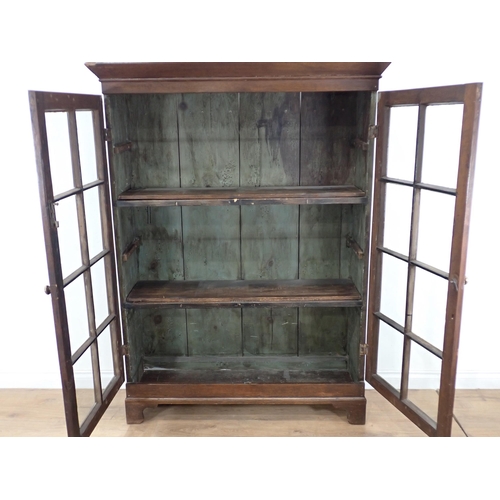 629 - An oak Bookcase fitted pair of glazed doors enclosing shelves on bracket feet 5ft 3in H x 3ft 11in W