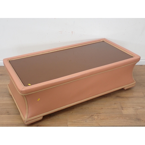 255 - A large glass topped Coffee Table covered in pink and cream leather type upholstery 4ft 6