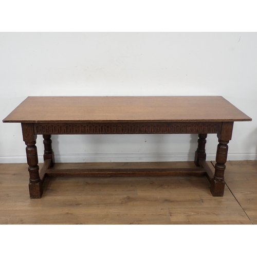 314 - An oak Refectory Dining Table and six oak framed Dining Chairs, the table have carved frieze and rai... 