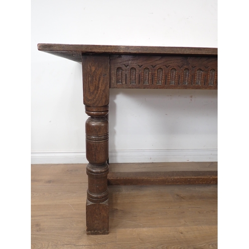 314 - An oak Refectory Dining Table and six oak framed Dining Chairs, the table have carved frieze and rai... 