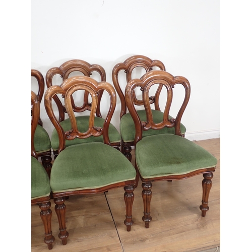 551 - A set of ten Victorian Dining Chairs with shaped backs, green upholstered stuff-over seats on balust... 