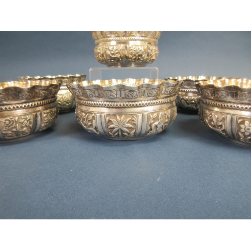 117 - Six Indian silver shaped circular Bowls embossed and chased with panels of animals, figures and flow... 