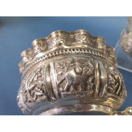 117 - Six Indian silver shaped circular Bowls embossed and chased with panels of animals, figures and flow... 