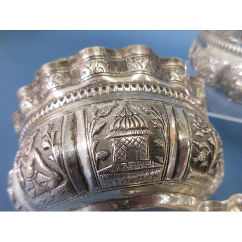 117 - Six Indian silver shaped circular Bowls embossed and chased with panels of animals, figures and flow... 