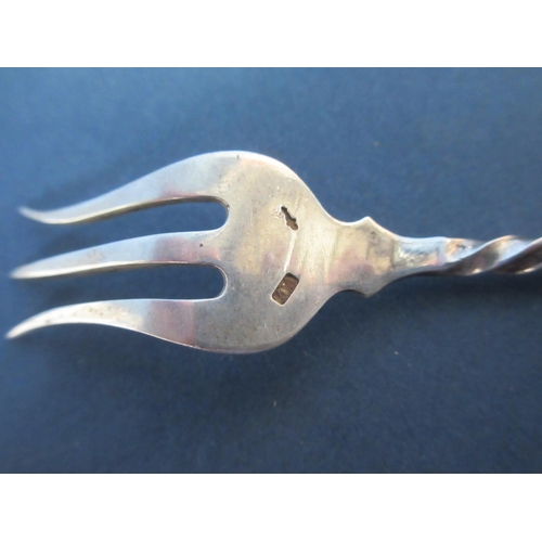 135 - A Continental silver Caddy Spoon, bead pattern, five Pickle Forks with spiral stems and white metal ... 