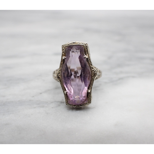 159 - An Amethyst Ring set lozenge shaped stone to pierced mount in white gold stamped 14K, ring size L