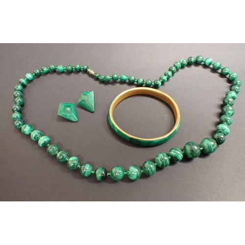 160 - A string of graduated Malachite Beads, a rigid Malachite Bangle and a pair of Malachite Ear Clips