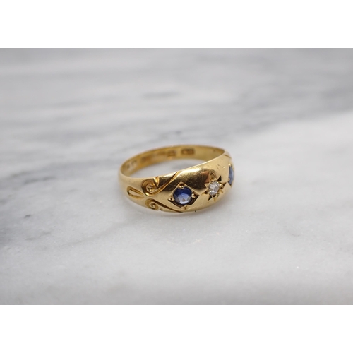 165 - A Diamond and Sapphire three stone ring gypsy-set old0cut diamond between two round sapphires in 18c... 