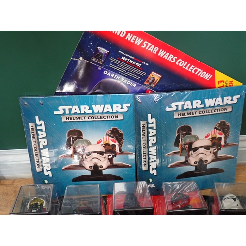 2 - Thirty boxed Star Wars Helmet Collection Models with two Booklets