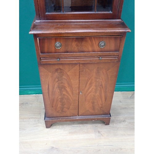 205 - A mahogany veneered narrow Bookcase fitted glazed door above base with single drawer and pair of cup... 