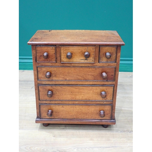 208 - A 19th Century fruitwood Apprentice Piece Chest of three short above three long drawers mounted on b... 