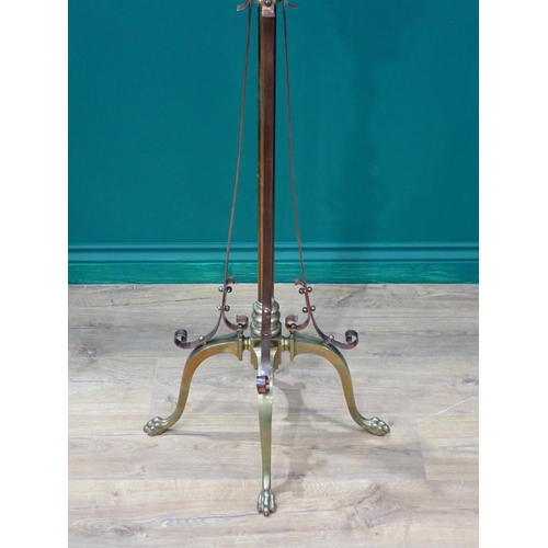 279 - An antique brass floor standing Oil Lamp mounted on four paw feet 5ft 6in H