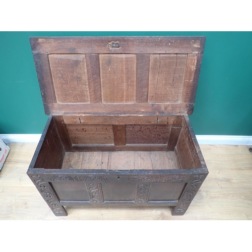 310 - A 17th Century oak Coffer with sunken three panel lid above three panel front with lunette carved fr... 