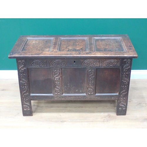 310 - A 17th Century oak Coffer with sunken three panel lid above three panel front with lunette carved fr... 