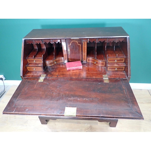 324 - A George III mahogany Bureau with fall front enclosing secret drawers, pigeon holes and inlaid drawe... 