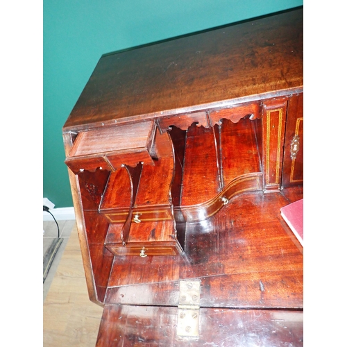 324 - A George III mahogany Bureau with fall front enclosing secret drawers, pigeon holes and inlaid drawe... 