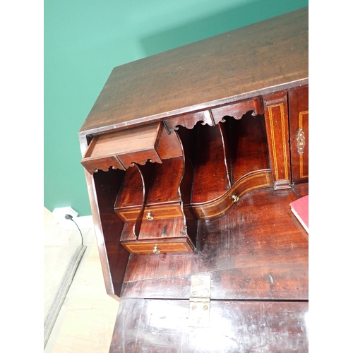 324 - A George III mahogany Bureau with fall front enclosing secret drawers, pigeon holes and inlaid drawe... 