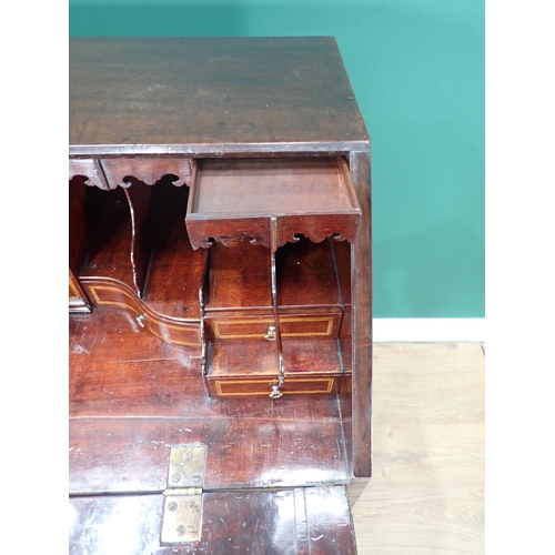 324 - A George III mahogany Bureau with fall front enclosing secret drawers, pigeon holes and inlaid drawe... 