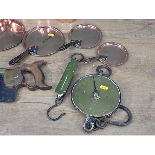 336 - A set of four antique graduated Cooking Pots and Lids, two sets of Scales and a Saw