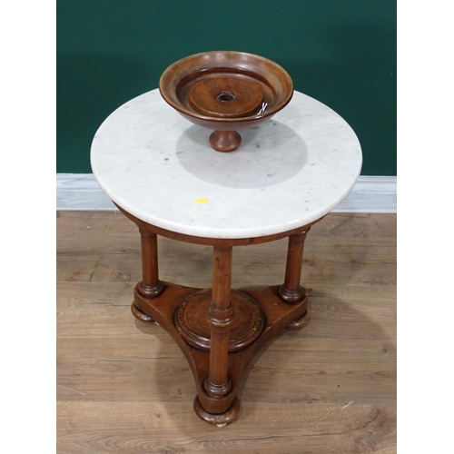 340 - A Victorian mahogany circular Wash Stand with marble top on three turned supports and concave platfo... 