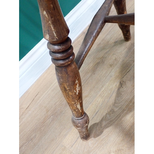 566 - A 19th Century ash Windsor Elbow Chair with pierced splat back on baluster turned supports and stret... 