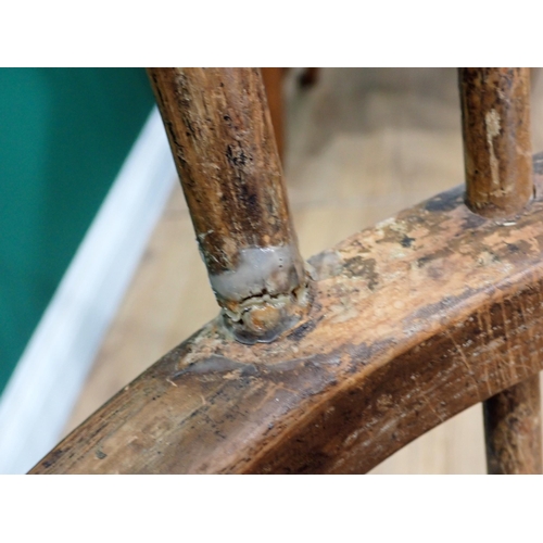 566 - A 19th Century ash Windsor Elbow Chair with pierced splat back on baluster turned supports and stret... 