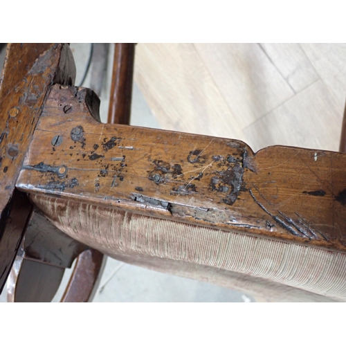 566 - A 19th Century ash Windsor Elbow Chair with pierced splat back on baluster turned supports and stret... 