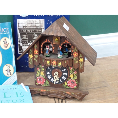 572 - A cuckoo Clock with acorn weights and a box of antique reference books