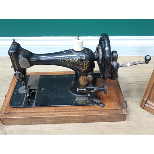 583 - A Singer Sewing Machine in case and another Victorian Sewing Machine and a Nest of Tables