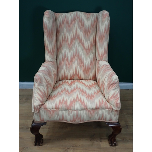 596 - A Georgian style Wingback Armchair with cream and pink upholstery mounted upon cabriole supports and... 