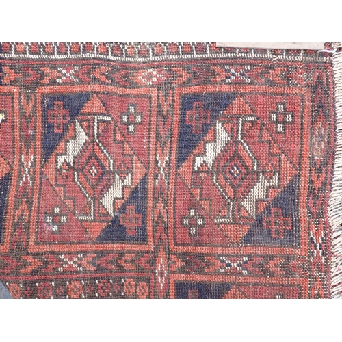 597 - An old red ground Persian Rug with panelled border 5ft 9in L x 3ft 3in W