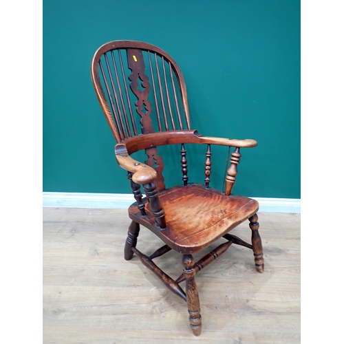 599 - A 19th Century ash Windsor style Armchair with pierced splat back mounted on turned supports with do... 