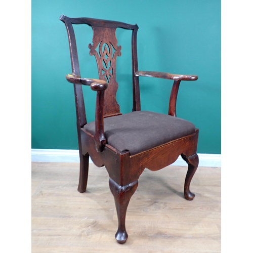 603 - An 18th Century oak Elbow Chair with pierced splat back and raised on cabriole front supports