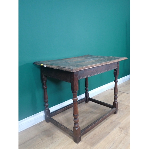 623 - An early 18th Century and later oak Side Table with moulded top on turned supports united by surroun... 