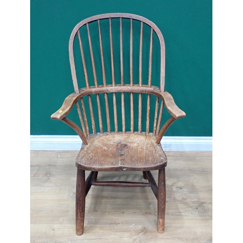 638 - A primitive 19th Century elm seated Windsor Elbow Chair with turned supports and stretchers and a 19... 