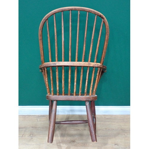 638 - A primitive 19th Century elm seated Windsor Elbow Chair with turned supports and stretchers and a 19... 