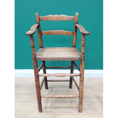 638 - A primitive 19th Century elm seated Windsor Elbow Chair with turned supports and stretchers and a 19... 