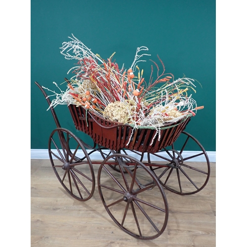 665 - An antique Pram with wooden shafts and spoked wheels