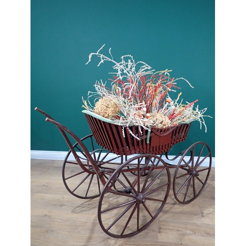 665 - An antique Pram with wooden shafts and spoked wheels