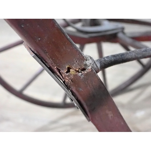 665 - An antique Pram with wooden shafts and spoked wheels