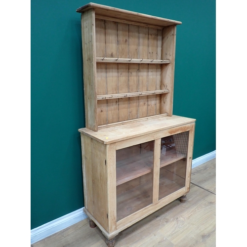 678 - An antique pine Dresser with rack above base fitted single glazed cupboard door 5ft 7in H x 3ft 3in ... 