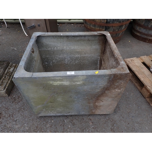 712 - A galvanised Water Tank and a quantity of Tins and glass Bottles