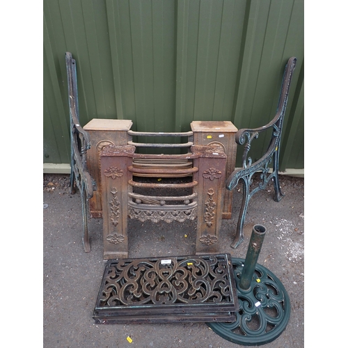 717 - Two cast iron Fire Grates, a pair of modern Bench Ends, a Parasol Stand and two metal Panels