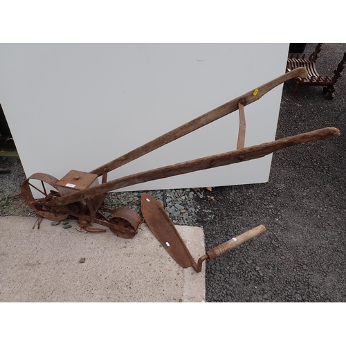 725 - An old hand push Seed Drill and a Hay Knife