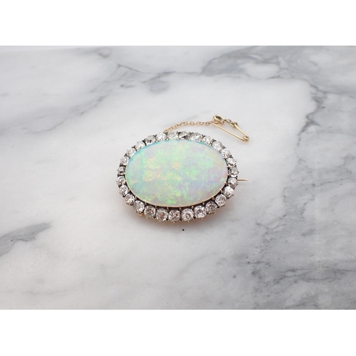 66 - An Opal and Diamond Brooch claw-set oval opal, approx 32mm x 22m within frame of old-cut diamonds, e... 