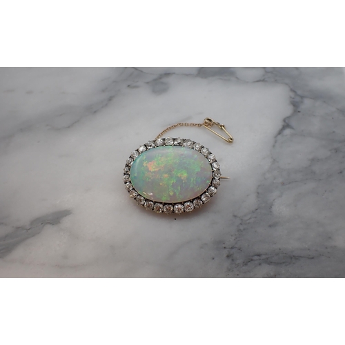 66 - An Opal and Diamond Brooch claw-set oval opal, approx 32mm x 22m within frame of old-cut diamonds, e... 