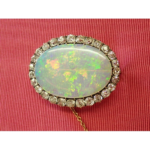 66 - An Opal and Diamond Brooch claw-set oval opal, approx 32mm x 22m within frame of old-cut diamonds, e... 