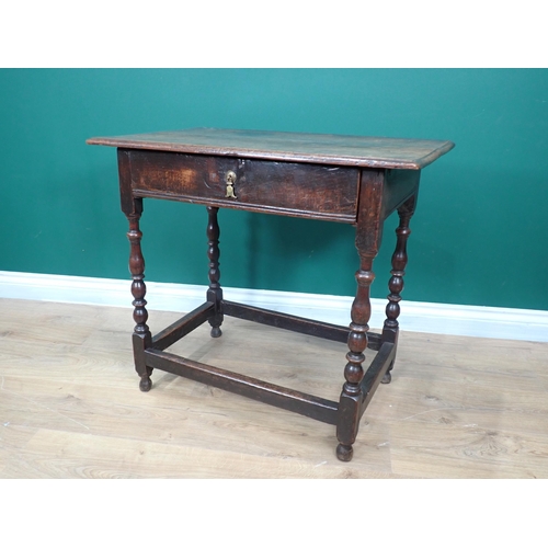 746 - A late 17th Century oak Side Table fitted frieze drawer and raised on baluster turned supports with ... 