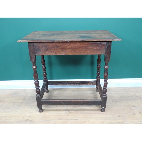 746 - A late 17th Century oak Side Table fitted frieze drawer and raised on baluster turned supports with ... 