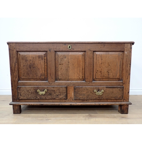 748 - An 18th Century oak Mule Chest with fielded three panel front above two drawers to base, mounted on ... 